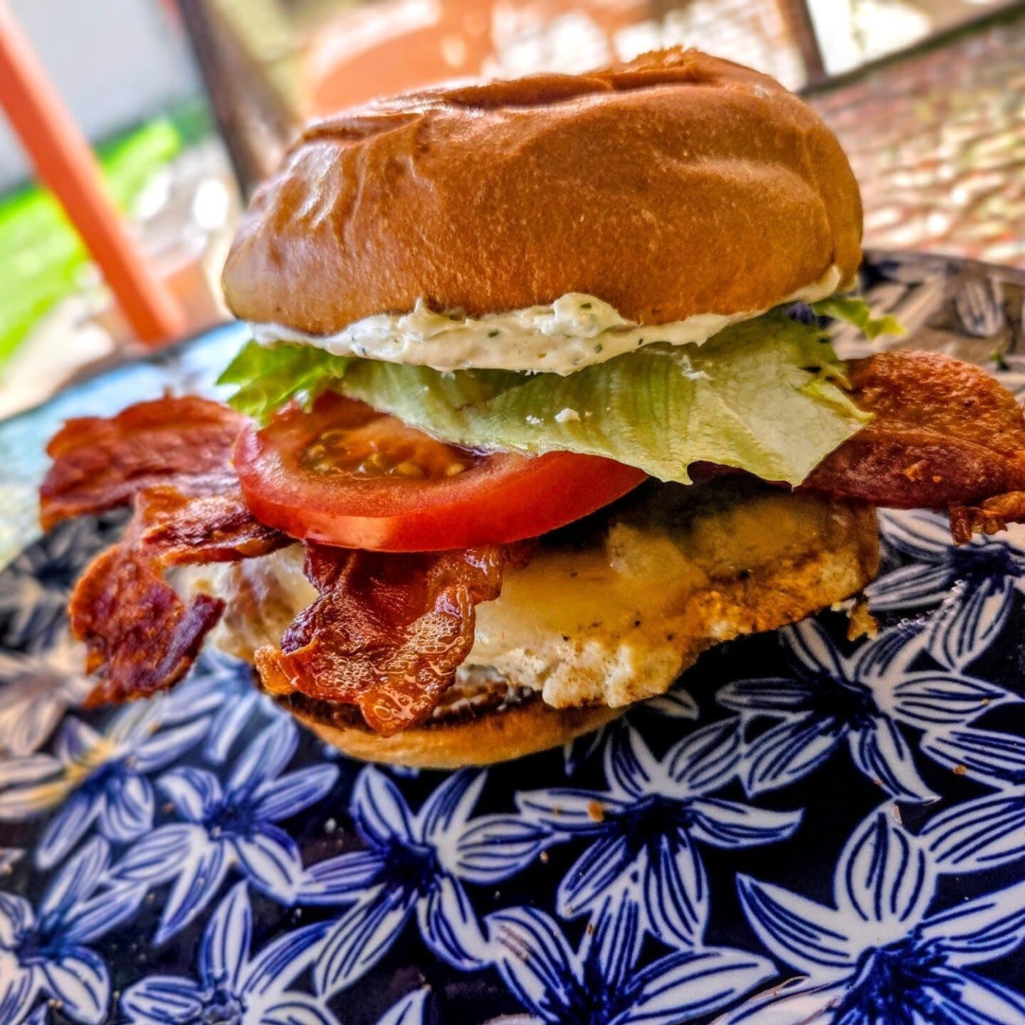 Chicken sandwich with lettuce and tomato on a brioche bun