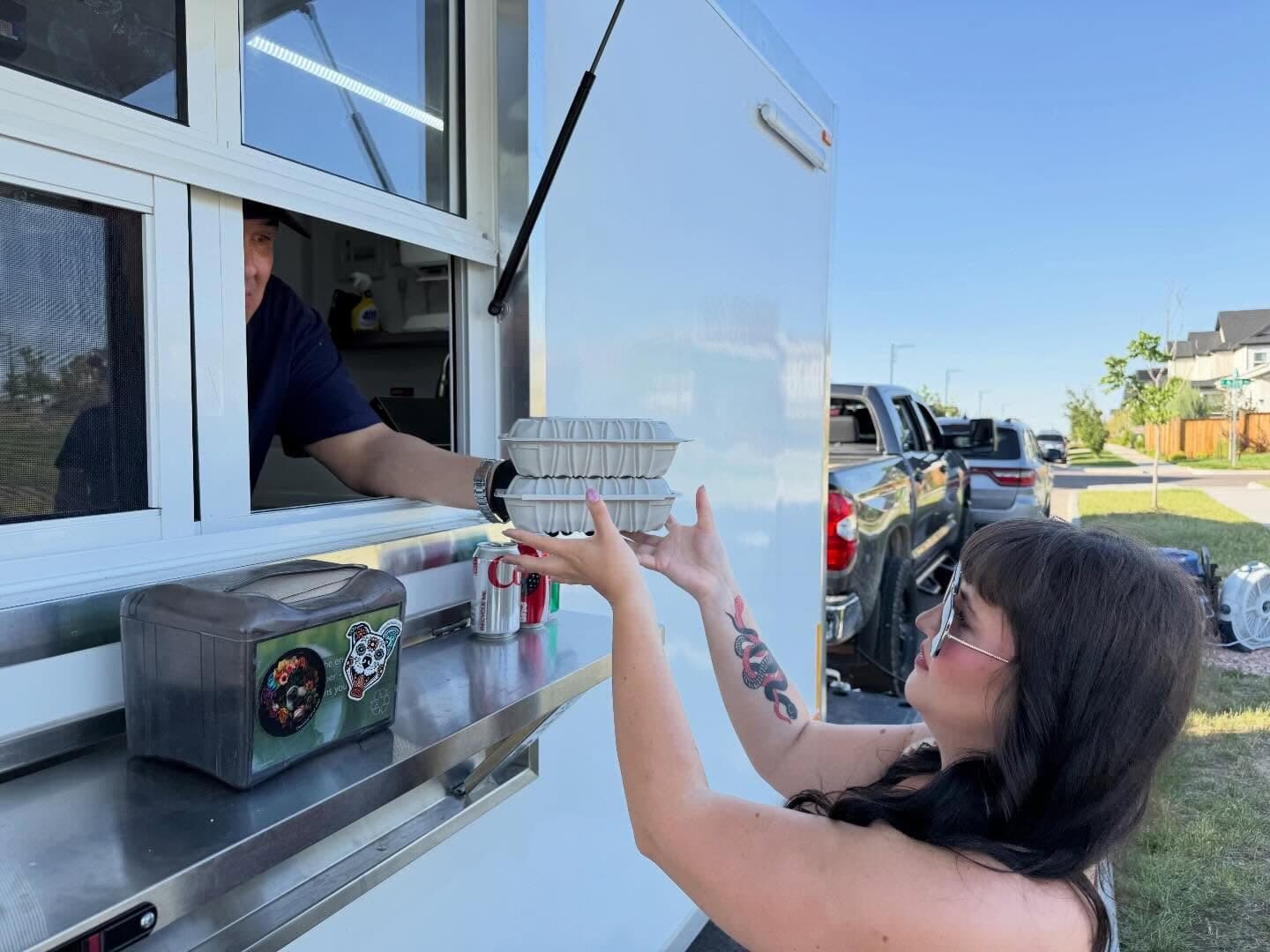 A customer being served at the TNLU food truck window
